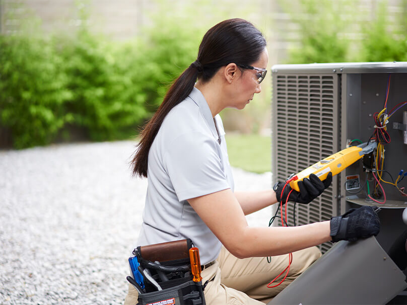 Woman working on an AC unit