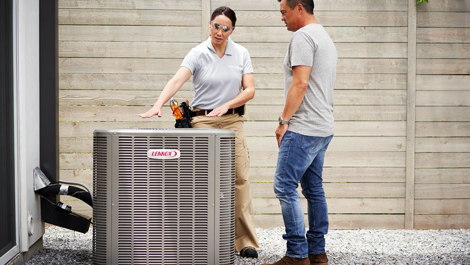 HVAC technician showing a customer a Lennox AC unit