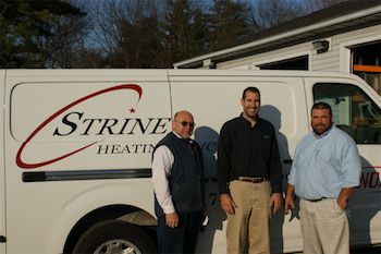 Group standing in front of a Strines van