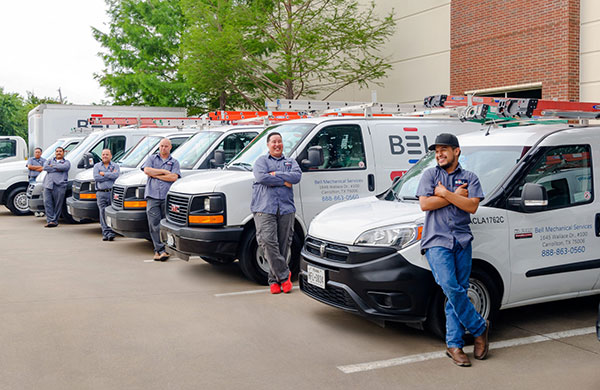 Dallas HVAC Technicians in front of their trucks